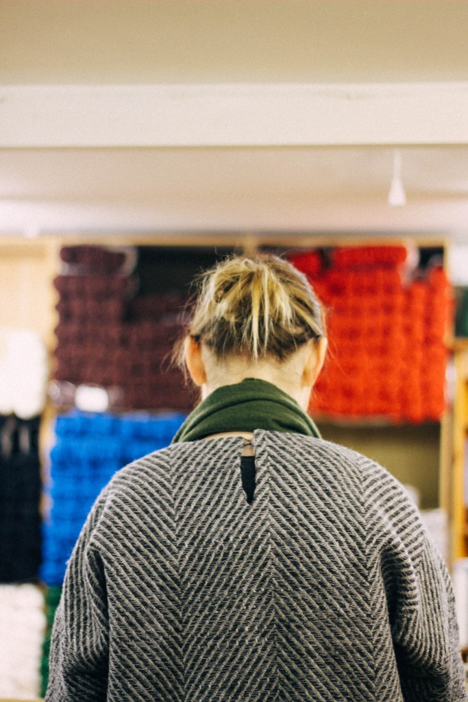 amy working at J&S in a jumper of her own weaving